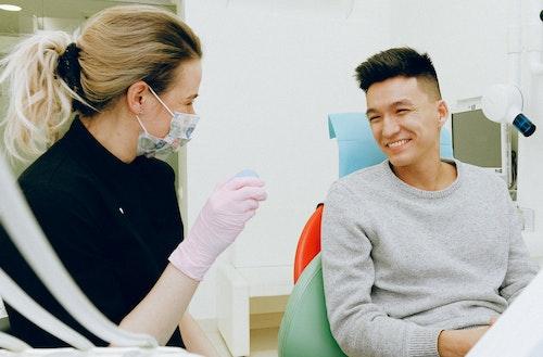 A dental hygienist cleaning a patient's teeth