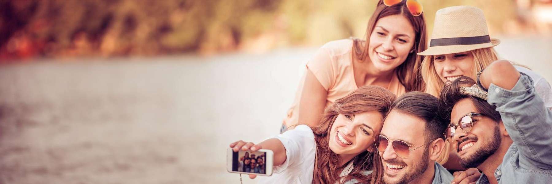 A group of friends taking a selfie at the beach