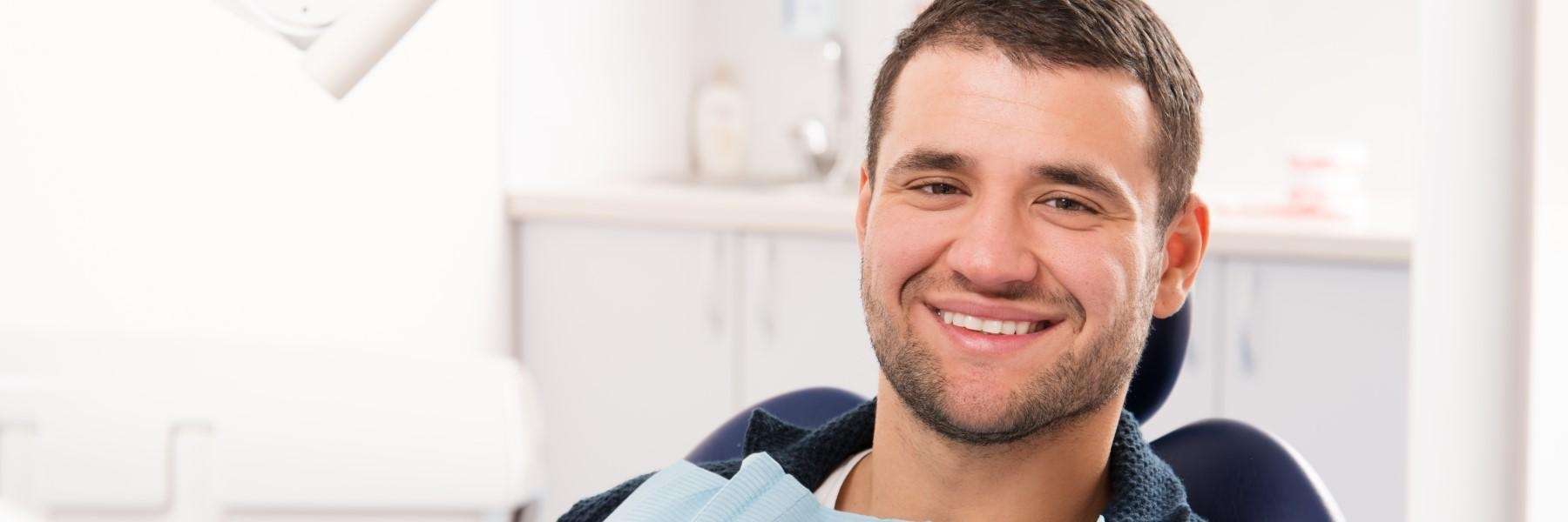 A smiling man getting a dental exam