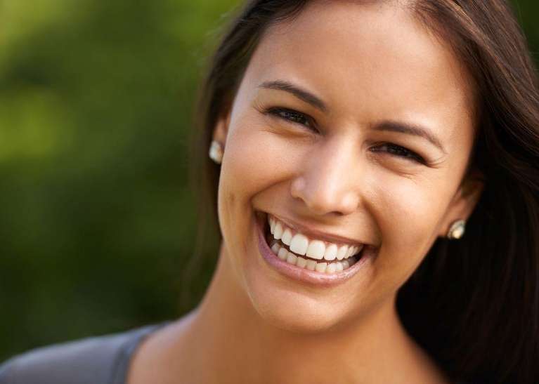 A smiling woman with dental crowns in Elk Grove