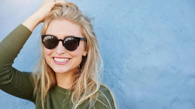 A smiling woman in sunglasses | Elk Grove dentist