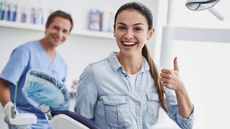 A smiling woman with her dentist