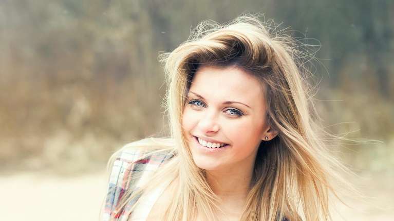 A smiling girl in the park | Dentist Elk Grove