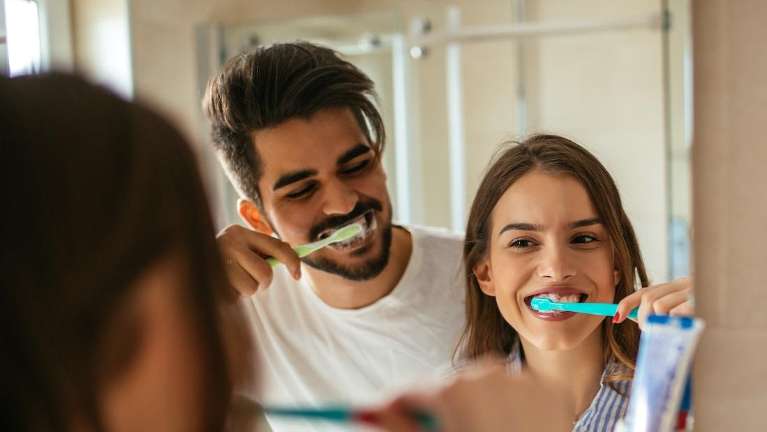 A couple brushing their teeth together | dentist elk grove