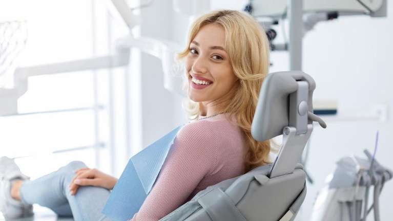 A woman smiling at the dentist's office | tooth extraction elk grove