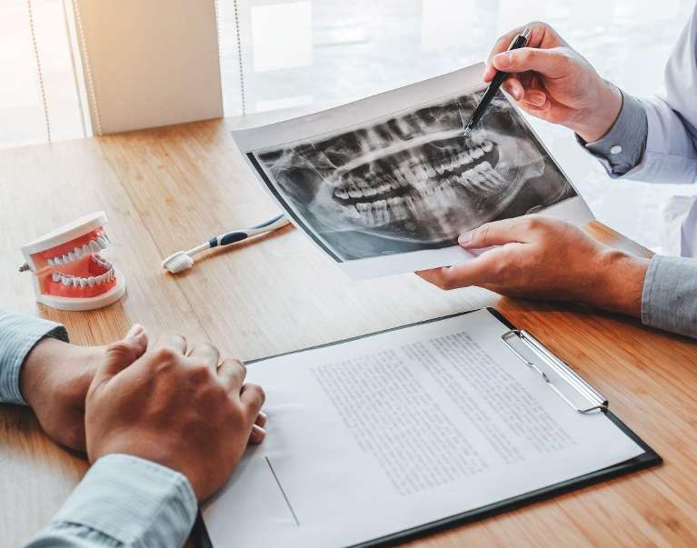 A dentist showing a patient his dental x-rays