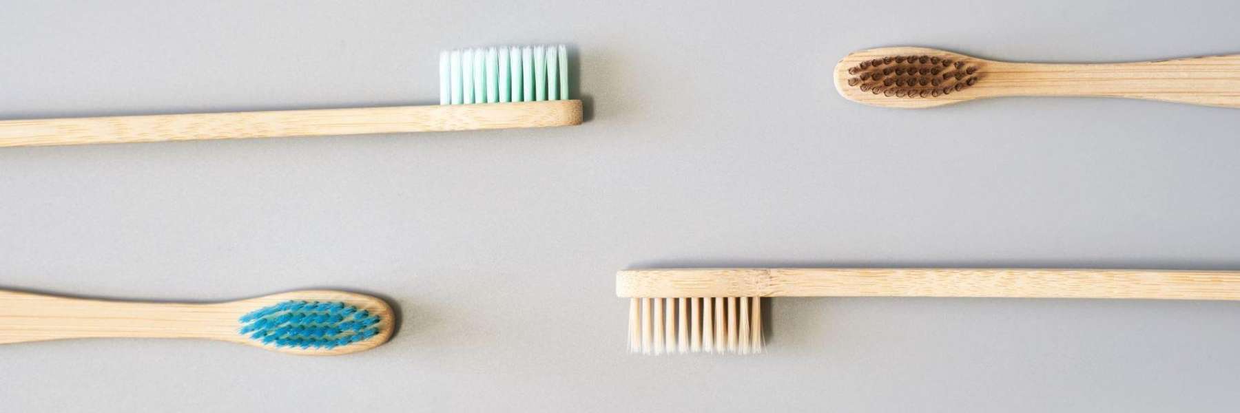 Four wooden toothbrushes