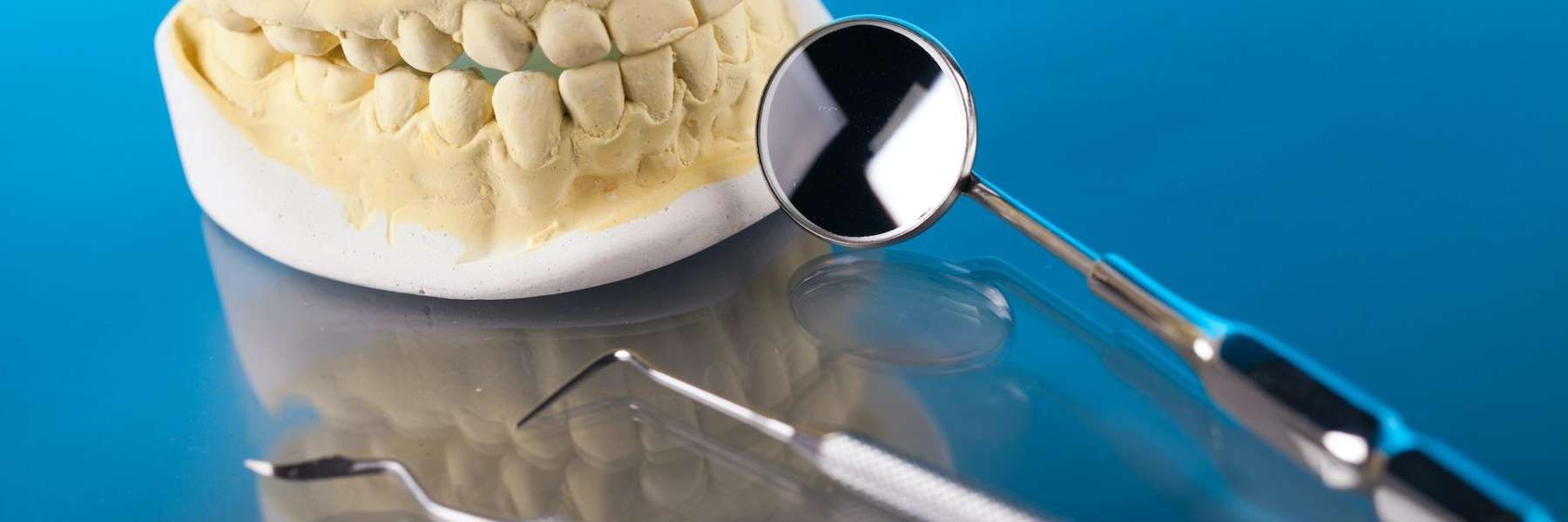Image of a dental mold and cleaning tools