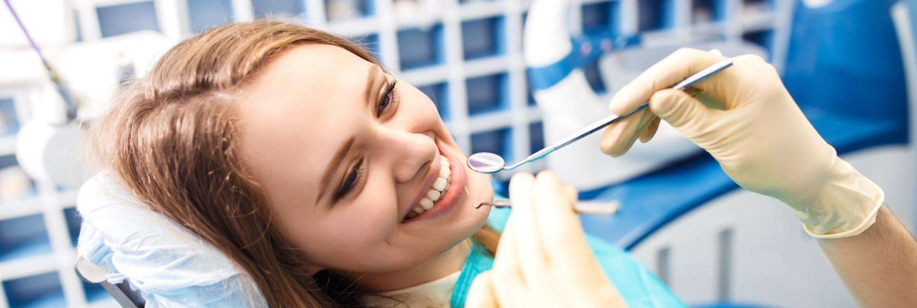 A smiling woman getting a dental exam