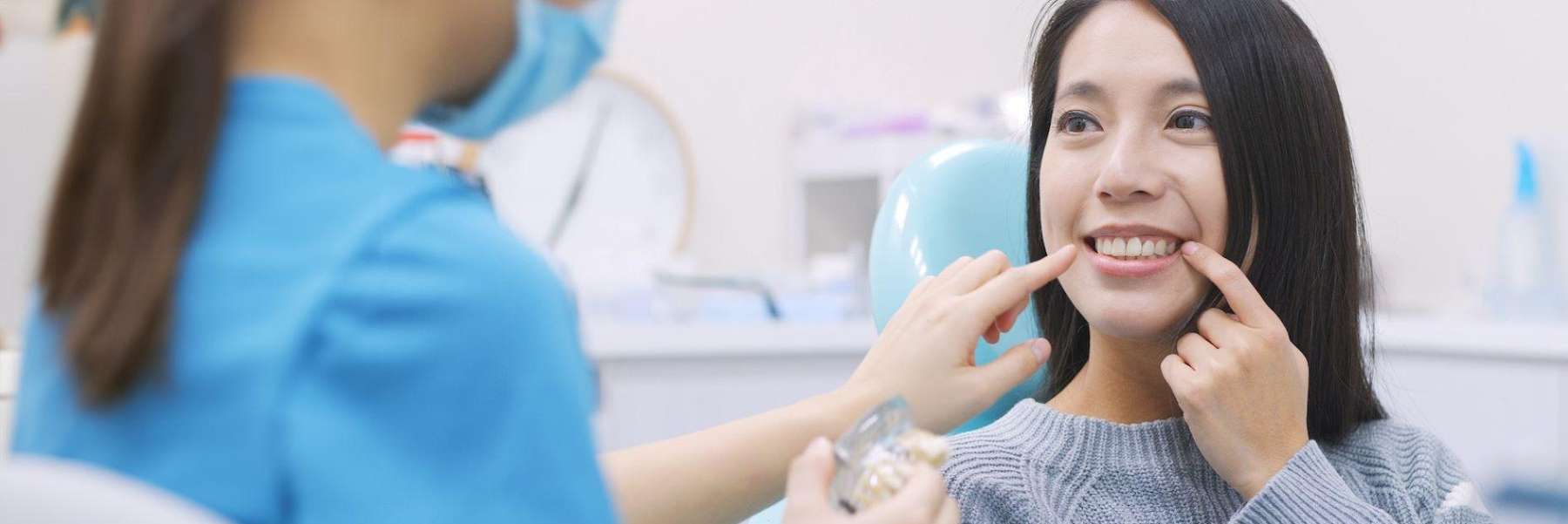 A smiling woman showing her dentist her teeth in Elk Grove