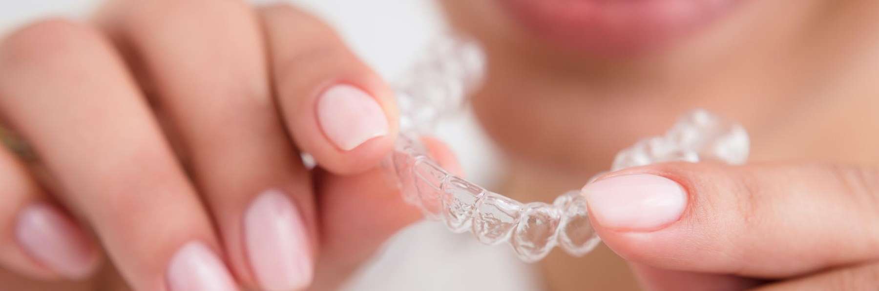 A woman putting in her Invisalign tray